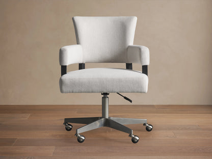 Fallyn Desk Chair in light gray fabric, shown in side view. Features padded seat and backrest on a metal swivel base with casters.