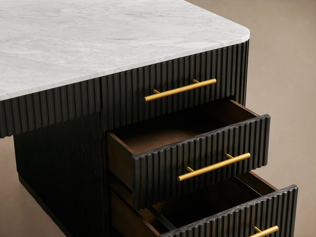 Finnley Executive Desk with dark reeded wood finish, brass handles, and white top. Features open storage drawers and sleek design.