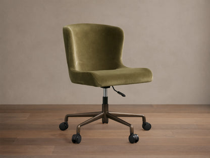 Kirsten Desk Chair, green velvet upholstery with a curved back, on a dark brown powder-coated aluminum base with 5 casters.