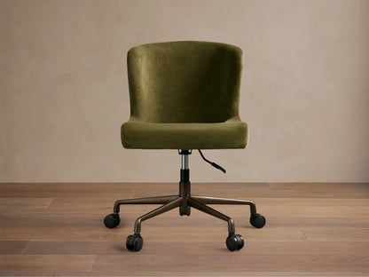 Kirsten Desk Chair, green velvet upholstery with a curved back, on a dark brown powder-coated aluminum base with 5 casters.
