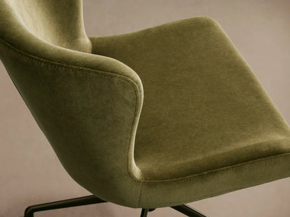 Kirsten Desk Chair with olive green velvet upholstery, bronze swivel base, and five casters, front view on a wooden floor.