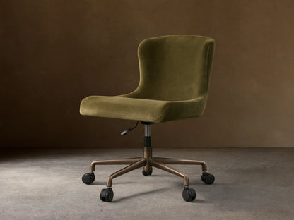Kirsten Desk Chair, green velvet upholstery with a curved back, on a dark brown powder-coated aluminum base with 5 casters.