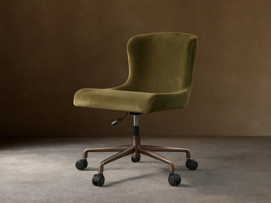 Kirsten Desk Chair, green velvet upholstery with a curved back, on a dark brown powder-coated aluminum base with 5 casters.