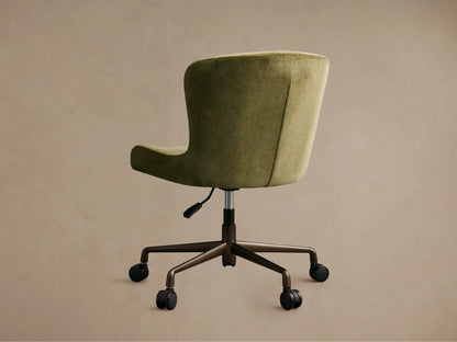 Close-up of Kirsten Desk Chair's olive green textured fabric seat & curved armrest with visible stitching; dark metal base.