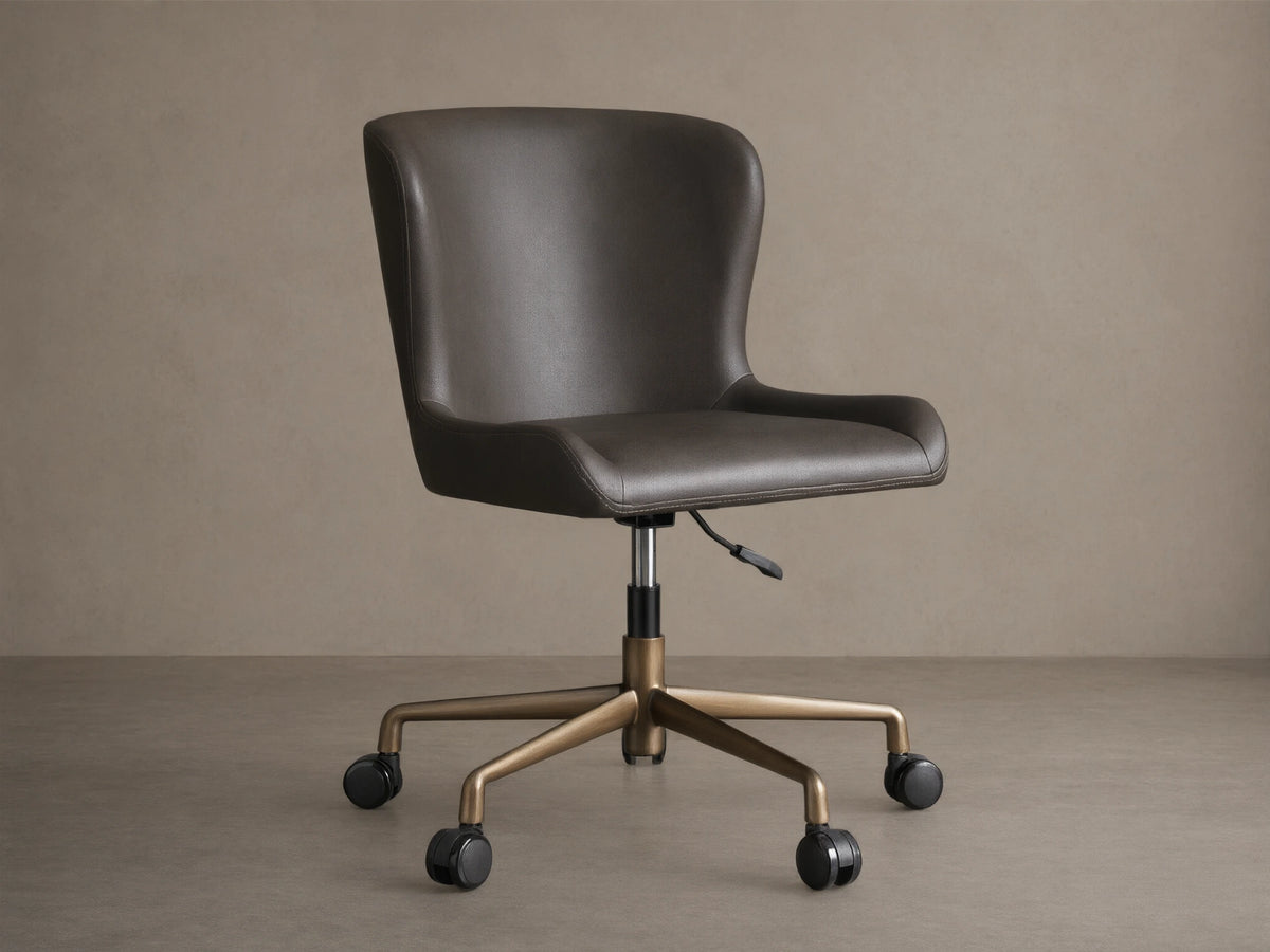 Kirsten Faux Leather Desk Chair with dark brown upholstery, aluminum base, and black casters on wood flooring.