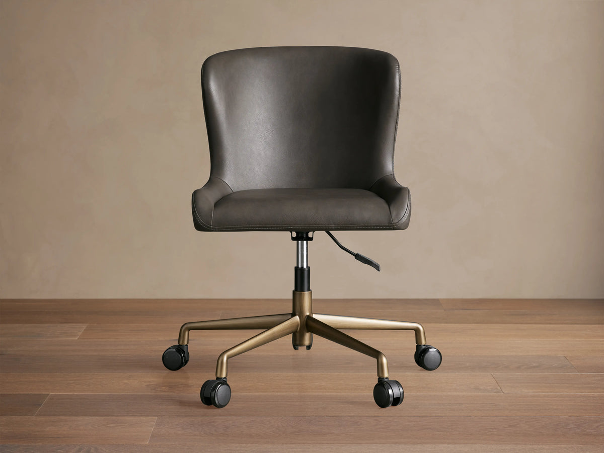 Kirsten Faux Leather Desk Chair with dark brown seat, gold powder-coated aluminum base, swivel feature, and black casters.