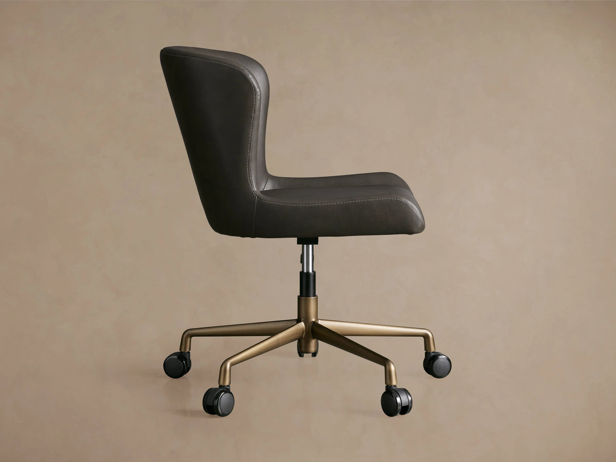 Kirsten Faux Leather Desk Chair in dark brown, side view. Features a powder-coated aluminum base, swivel mechanism, and casters.