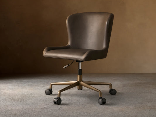 Kirsten Faux Leather Desk Chair with dark brown upholstery, aluminum base, and black casters on wood flooring.