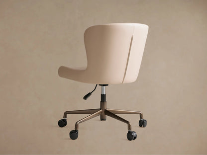 Kirsten Faux Leather Desk Chair, angled close-up of cream faux leather seat and curved back with detailed stitching.