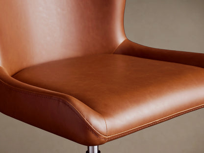 Kirsten Faux Leather Desk Chair in brown with smooth, sleek texture, cushioned seat and backrest, against a neutral background.