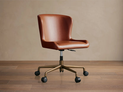 Kirsten Faux Leather Desk Chair in brown, rear view. Features a curved backrest, aluminum swivel base with casters, and height adjustment lever.