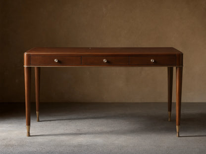Front view of a dark brown wooden desk with three drawers, round silver knobs, and slim tapered legs with brass caps.