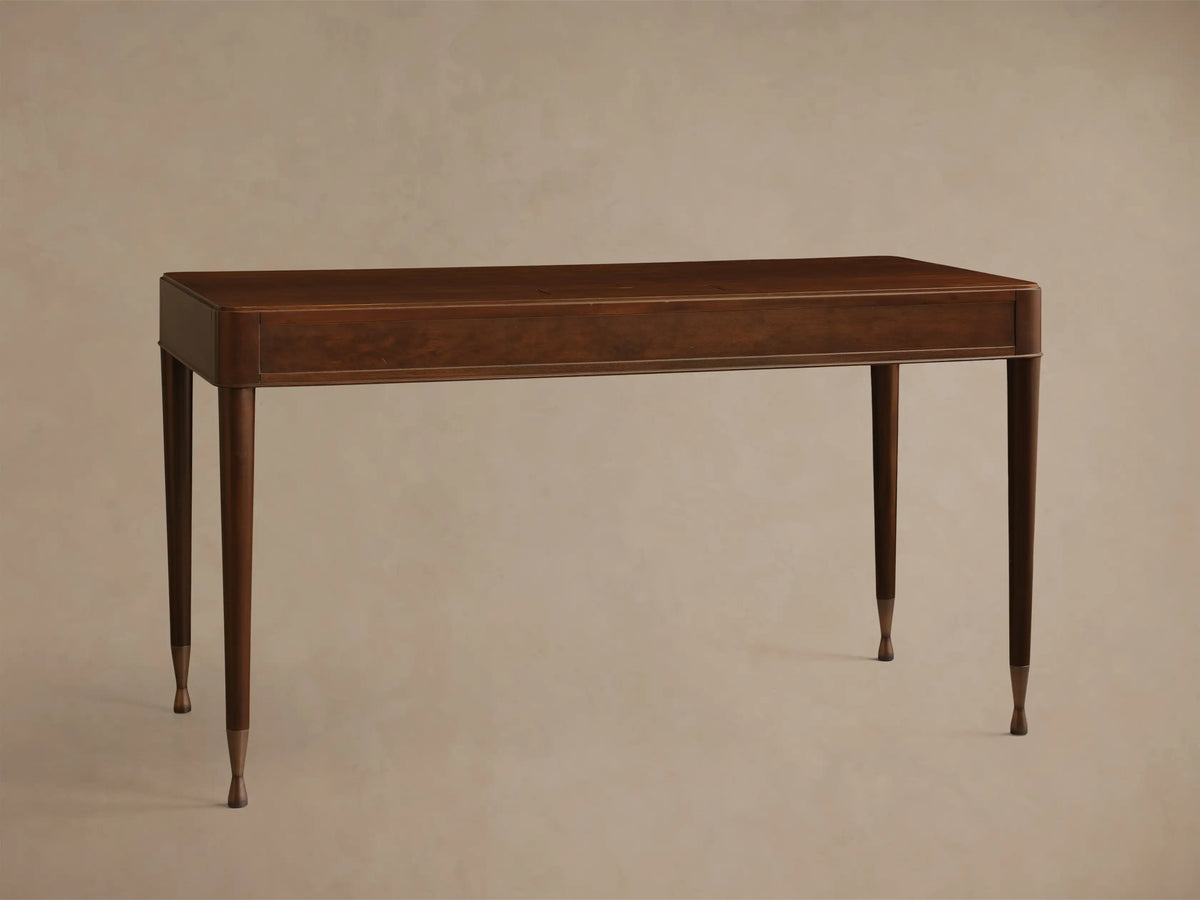 Front view of a dark brown wooden desk with three drawers, round silver knobs, and slim tapered legs with brass caps.