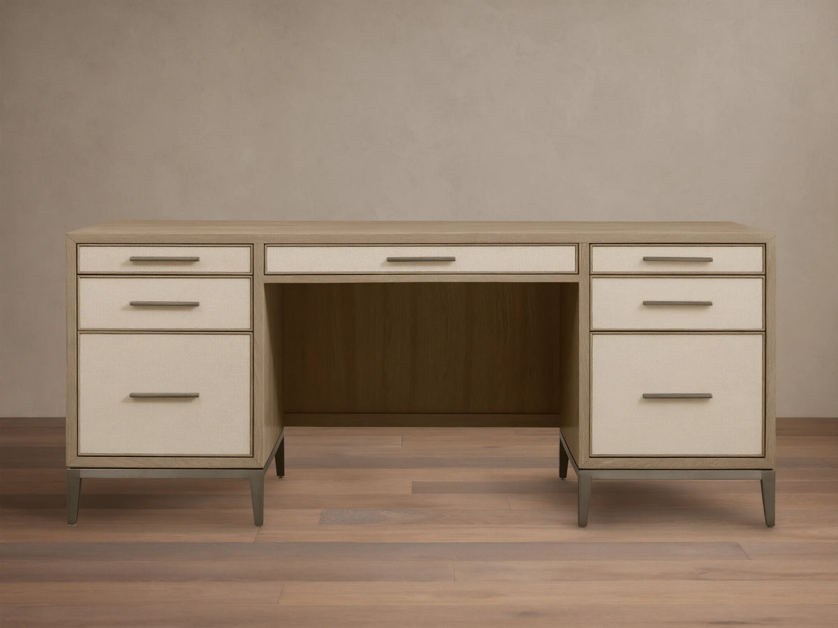 Front view of a Bone Malone Executive Desk with off-white shagreen leather drawer fronts and dark steel legs.