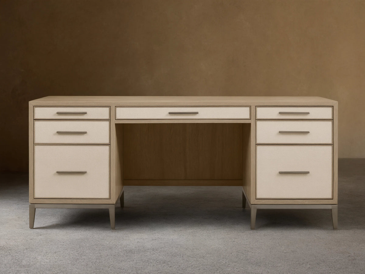 Front view of a Bone Malone Executive Desk with off-white shagreen leather drawer fronts and dark steel legs.