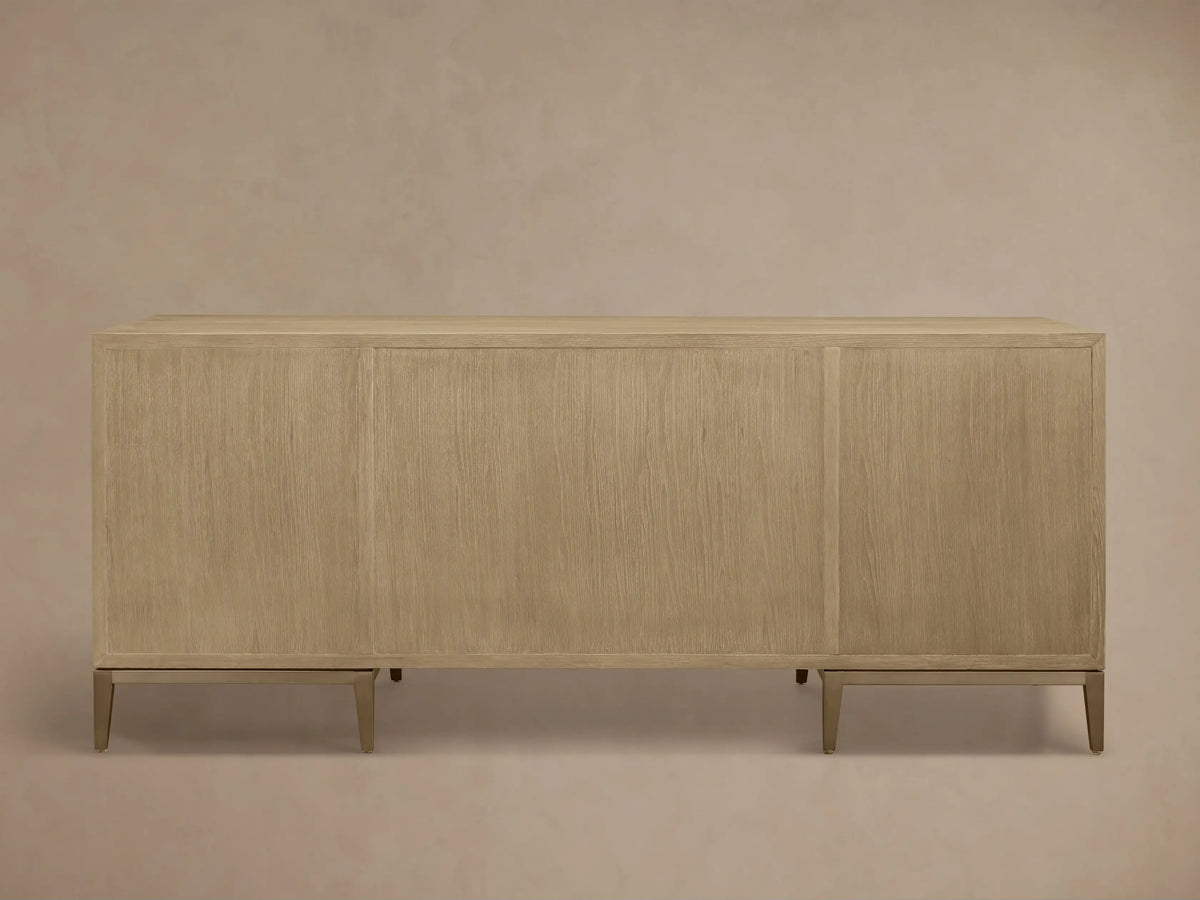 Angled close-up of the light wood Malone Executive Desk, featuring cream shagreen-textured drawer fronts with dark gray handles.