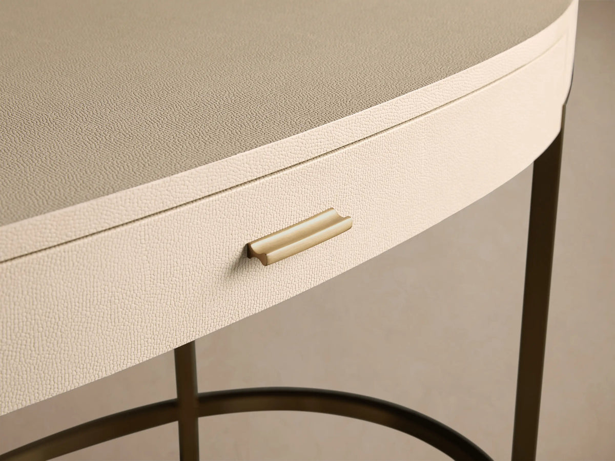 Close-up of the Malone Writing Desk, featuring a light beige shagreen-textured drawer with a gold pull handle and a neutral beige top.