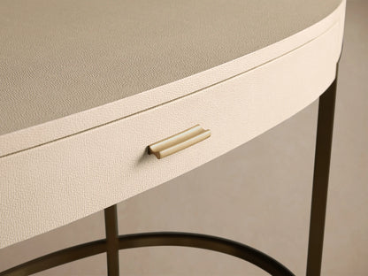 Close-up of the Malone Writing Desk, featuring a light beige shagreen-textured drawer with a gold pull handle and a neutral beige top.