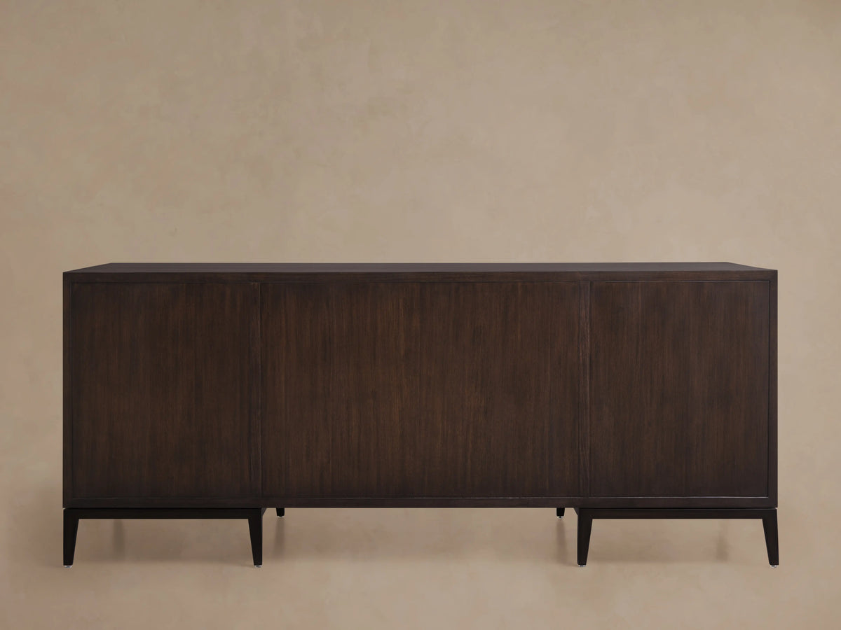 Dark wood executive desk with a minimalist design and clean lines. Features a flat top and sturdy legs against a neutral background.