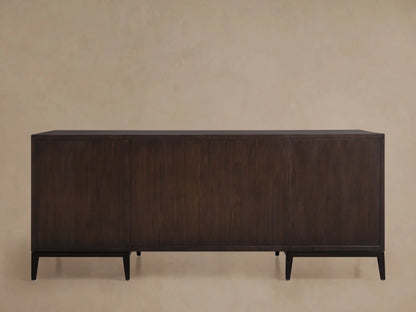 Dark wood executive desk with a minimalist design and clean lines. Features a flat top and sturdy legs against a neutral background.