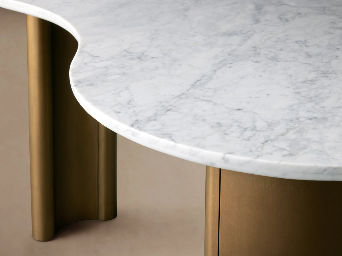 Kidney-shaped Marlie Writing Desk with a white marble top, displaying unique veining, on antique copper-finished rubberwood bases.