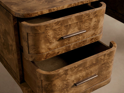 Close-up of the Mogadore Executive Desk, featuring two curved drawers partially open, crafted from mappa burl wood with antique brass handles.