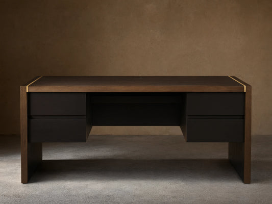 Mihaela Executive Desk in dark wood with gold trim, featuring four drawers and a sleek, modern design on a wooden floor.