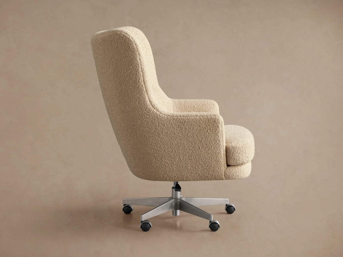 Back view of Montrose Desk Chair with light beige textured upholstery, silver five-star swivel base, and casters.