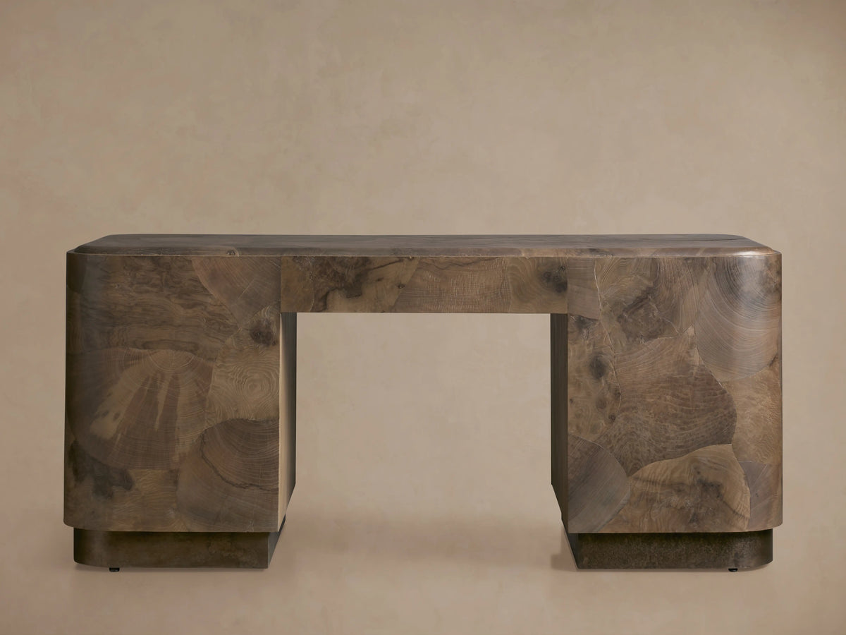 Polanco Executive Desk made of oyster-cut wood with unique graining, standing on aged steel base. Features a smooth top and push-to-open doors.