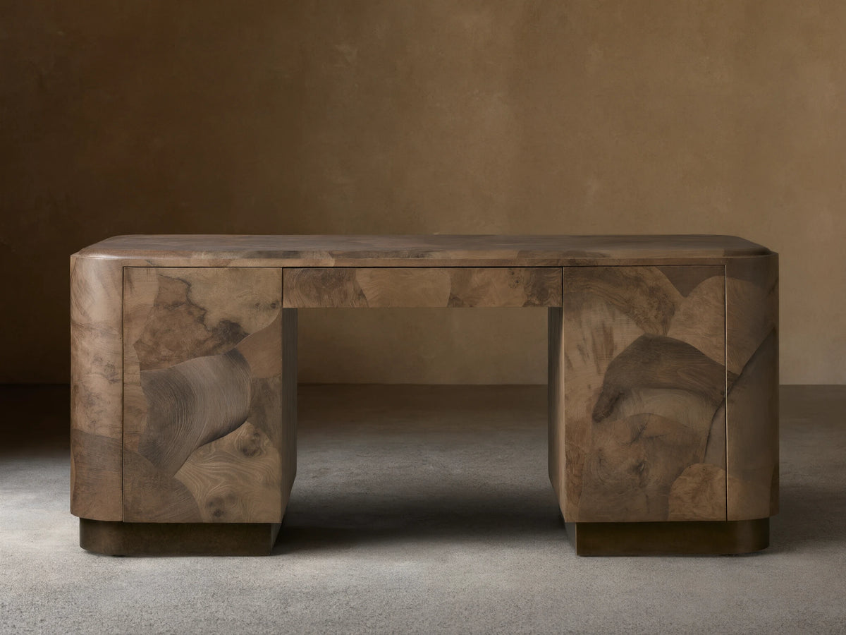 Polanco Executive Desk made of oyster-cut wood with unique graining, standing on aged steel base. Features a smooth top and push-to-open doors.