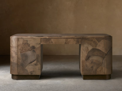 Polanco Executive Desk made of oyster-cut wood with unique graining, standing on aged steel base. Features a smooth top and push-to-open doors.