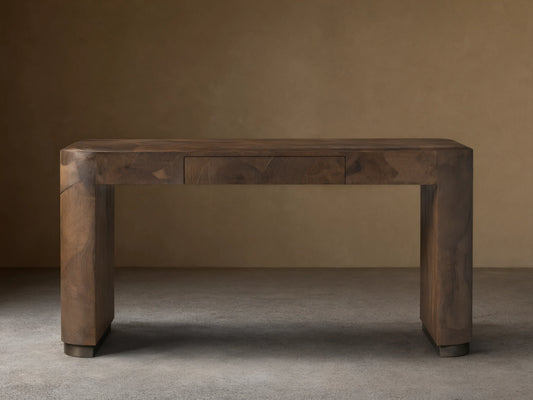 A rectangular Polanco Writing Desk crafted from oyster-cut salvaged wood with a natural finish. Features a center drawer and ledge detailing.