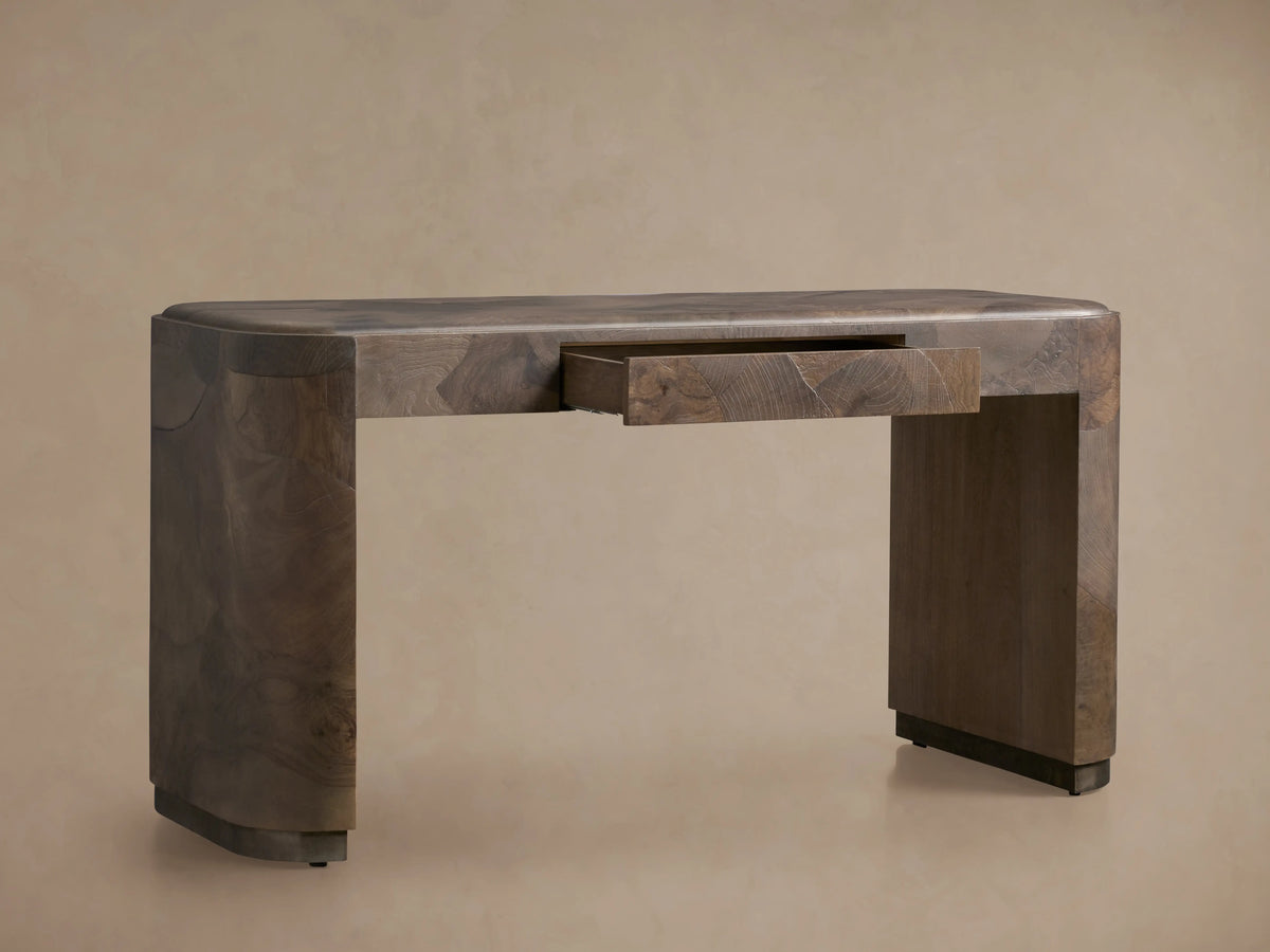 Polanco Writing Desk with a smooth, rounded edge and open center drawer. Made from oyster-cut ash, displaying natural wood grain patterns.