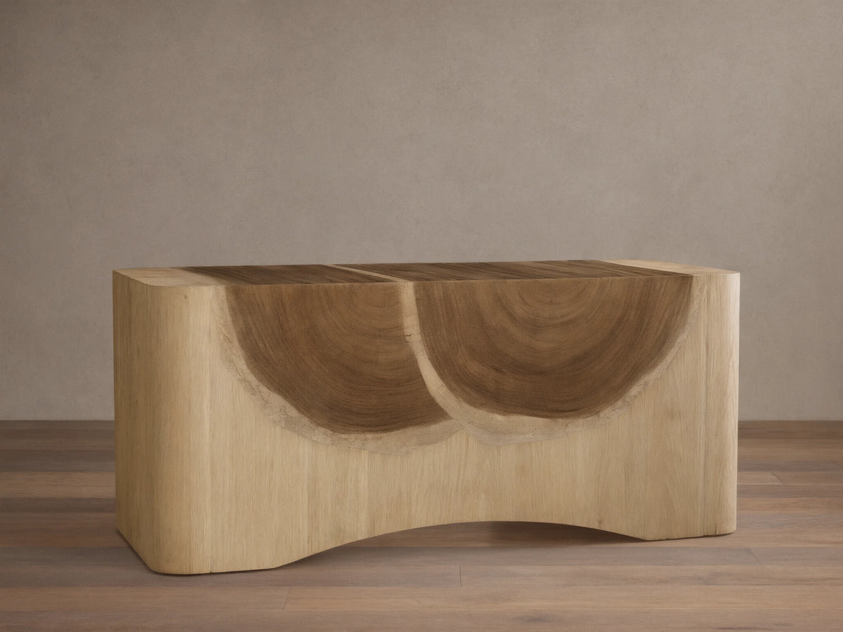 Ramiro Executive Desk, front view. Light wood with prominent dark, semicircular Guanacaste grain pattern, rounded edges.