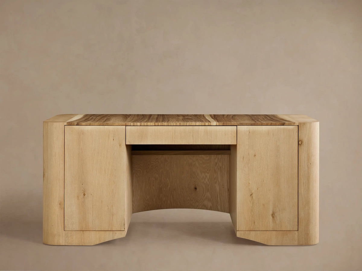 Ramiro Executive Desk close-up: open side cabinet with light oak wood, interior shelf, and darker Guanacaste wood inlay top.