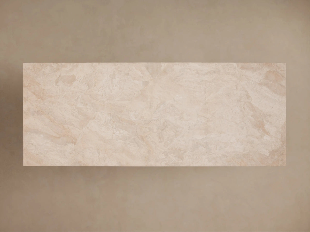 Sarsen Stone Desk corner view, showcasing smooth beige stone texture and a gold-toned inner shelf. Elegant and minimalist design.