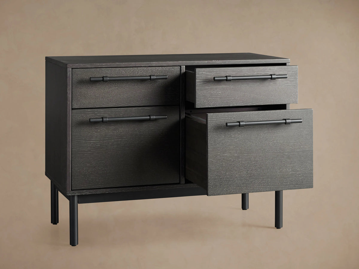 Sullivan File Cabinet in Northman Oak with a partially open drawer, showcasing black iron handles and a textured wood surface.