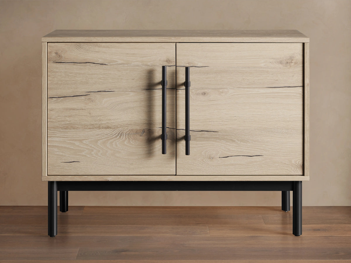 Sullivan Hall Chest made from reclaimed oak with visible wood grain, black resin-filled cracks, and black iron handles, standing on black legs.