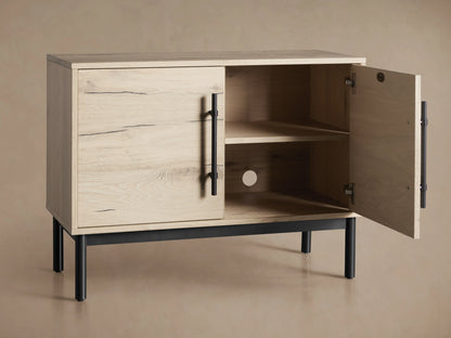 Sullivan Hall Chest made from reclaimed oak with visible wood grain, black resin-filled cracks, and black iron handles, standing on black legs.
