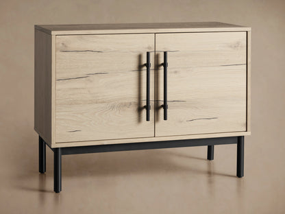 Sullivan Hall Chest in light oak with open and closed doors, black iron handles, and black metal legs on a beige background.