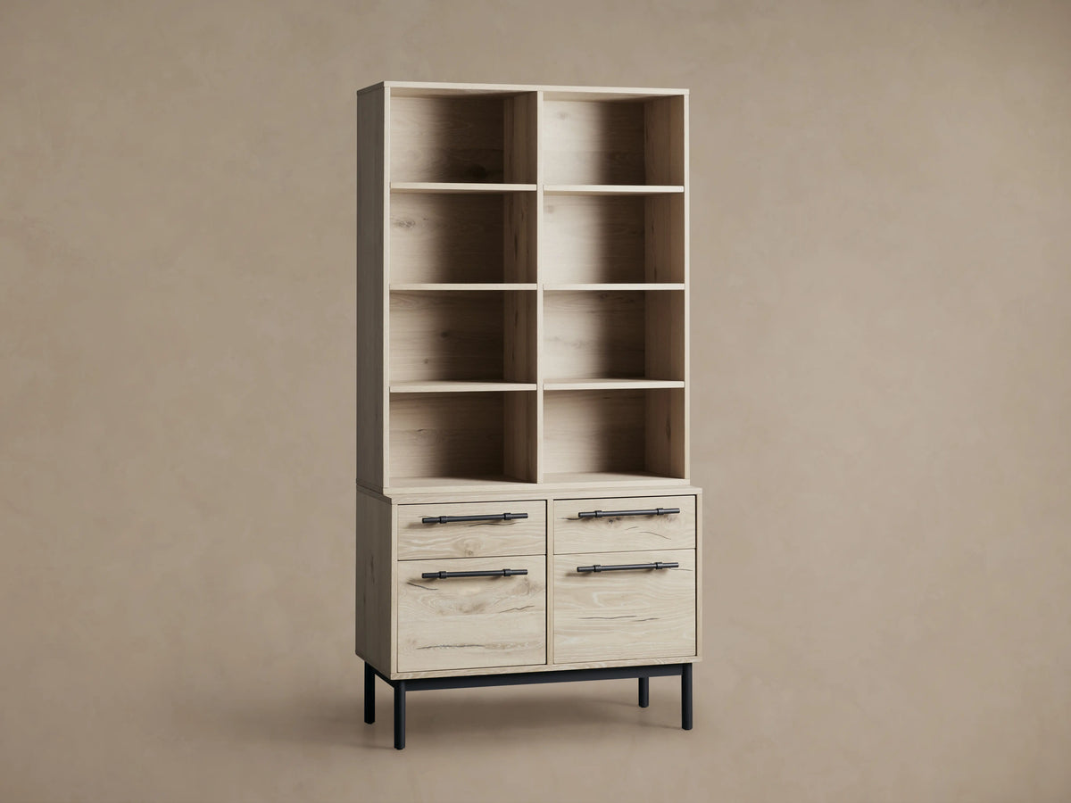 Sullivan Bookcase with File Base in light Northman Oak finish, featuring six open shelves and four drawers, two partially open, with black iron handles.