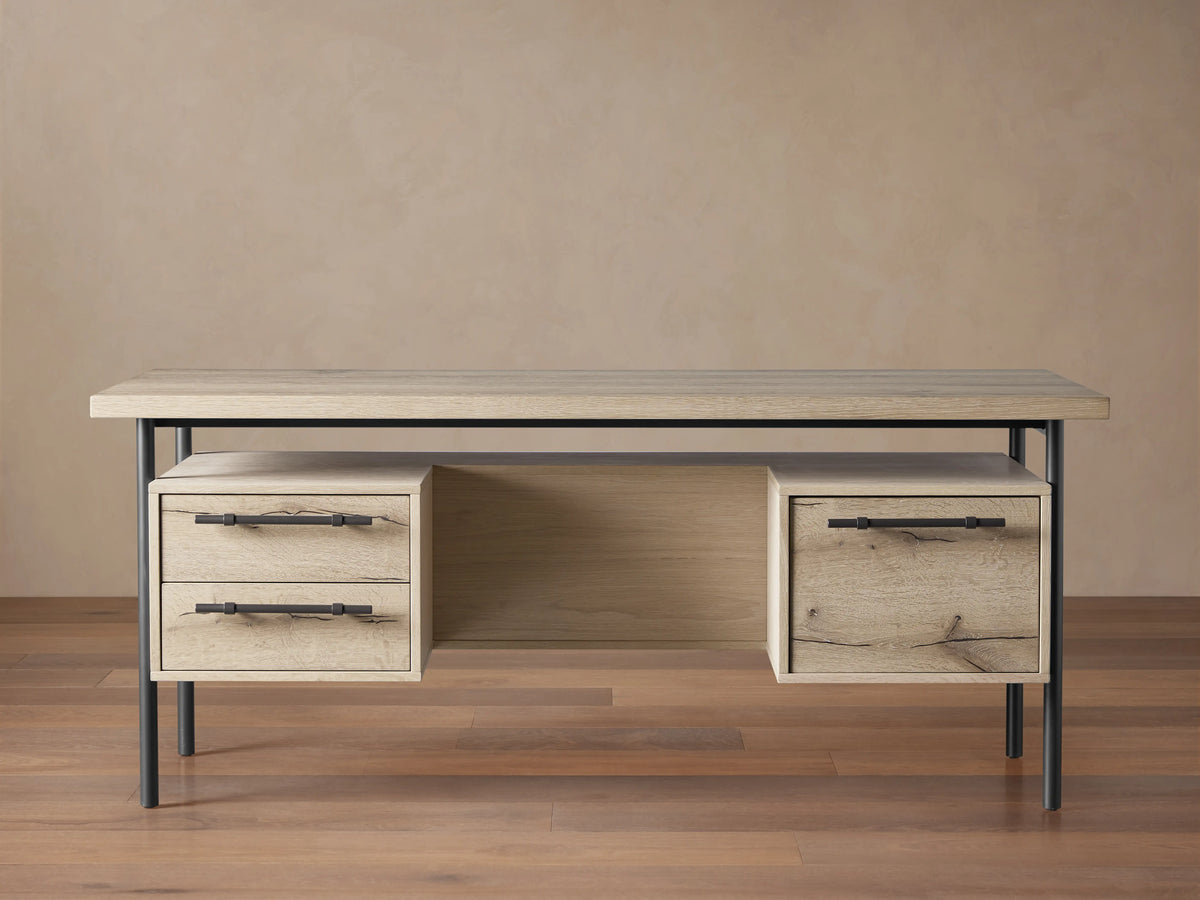 Sullivan Executive Desk in light oak with two drawers featuring black iron handles, set on a metal frame, highlighting natural wood textures.