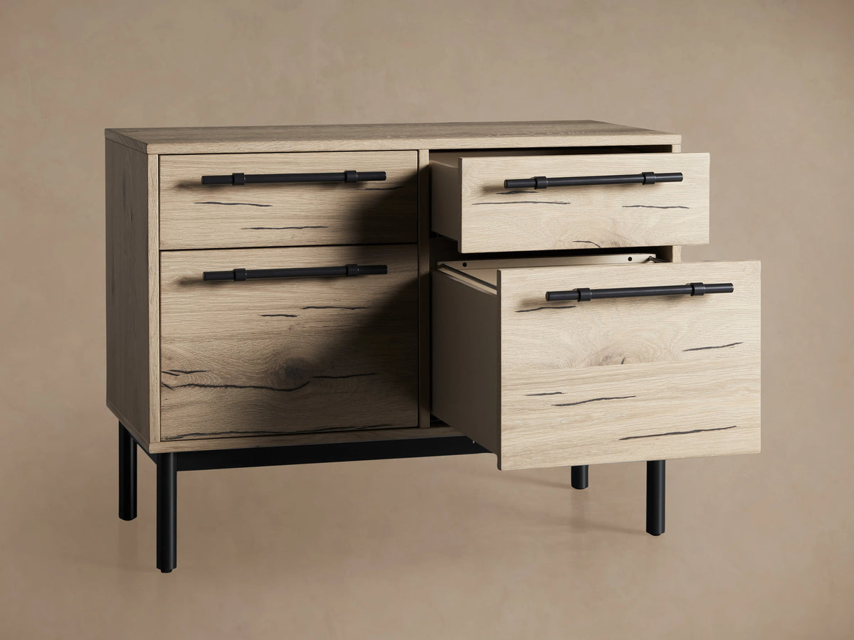 Sullivan File Cabinet in Northman Oak finish, featuring four drawers with black iron handles, displaying natural wood grain and cracks.