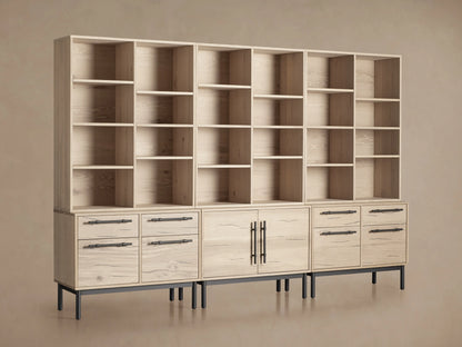Sullivan Triple Bookcase in natural oak finish, showcasing adjustable shelves and iron-handled drawers. Placed on a wooden floor.