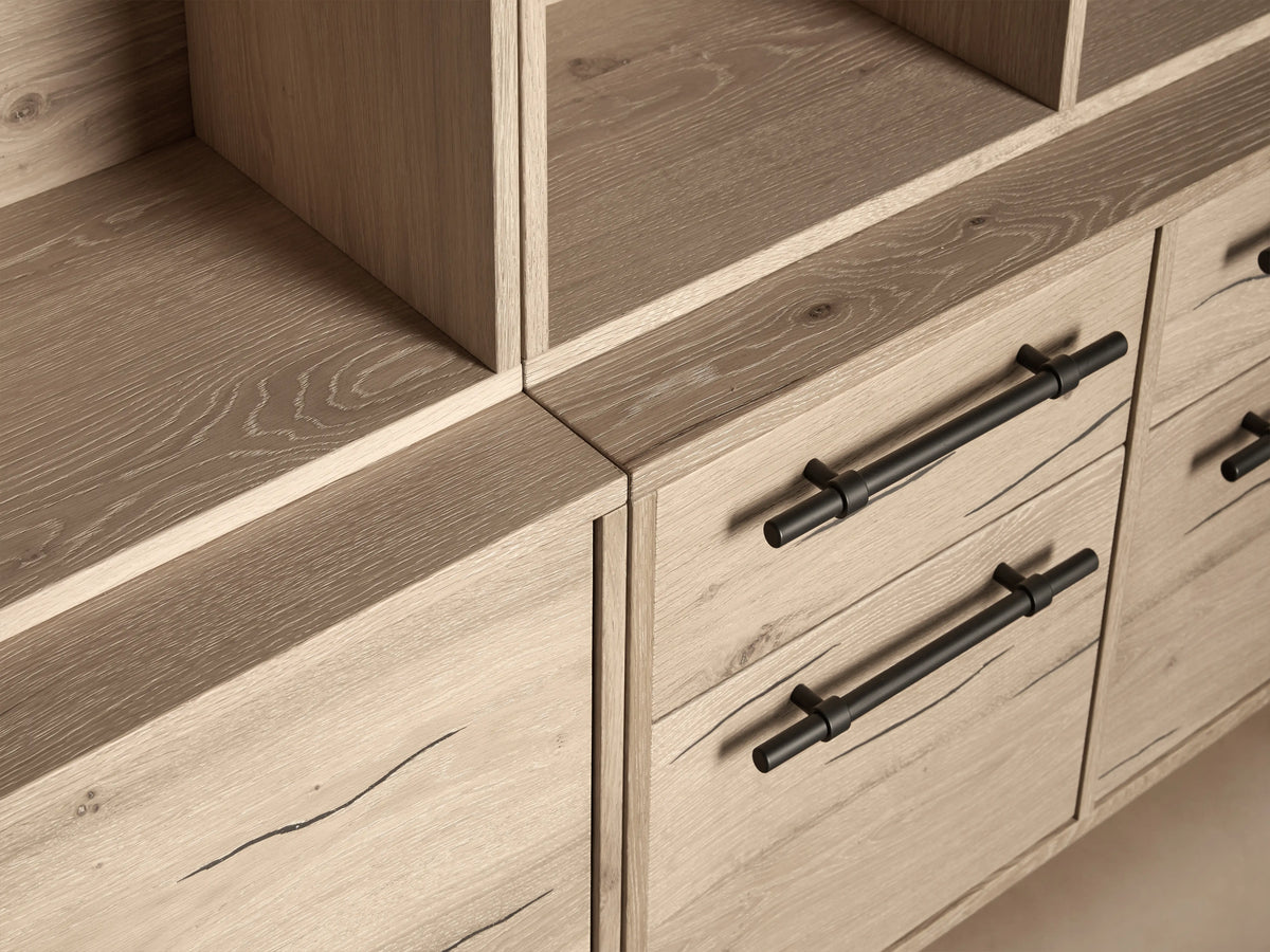 Sullivan Triple Bookcase made of light reclaimed oak, featuring multiple shelves, solid iron handles, and black metal legs.