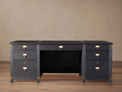 Telegraph Executive Desk in dark wood finish with brass hardware, featuring multiple drawers and open center space, on a wooden floor.