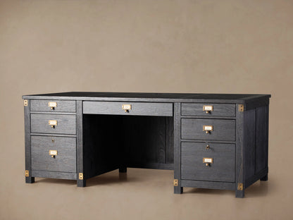 Telegraph Executive Desk in dark wood finish with brass hardware, featuring multiple drawers and open center space, on a wooden floor.