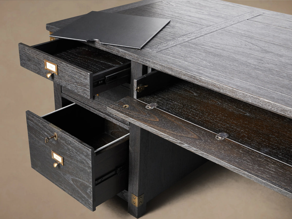 Top view of the Telegraph Executive Desk in dark wood finish, showing a hidden compartment with a three-plug media outlet and removable tray.