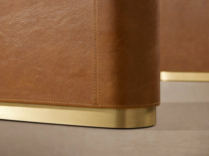 Brown leather Tullson Desk with smooth curved edges showing detailed stitching and wooden side panel.