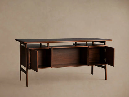 Towry Executive Desk in dark reddish-brown mahogany, black glass top, with a central open shelf and two closed side doors.